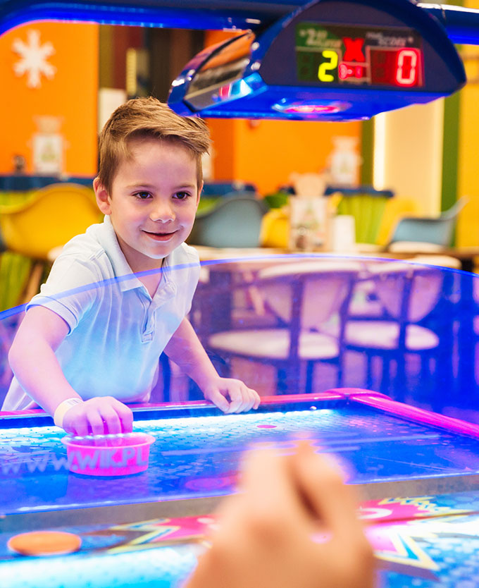 Young Boy Plaing Air Hockey