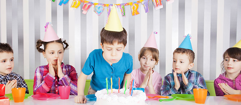 birthday-pack01 Young Boy Blows Out Candles With Friends